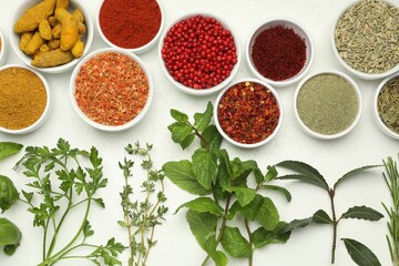 Different aromatic spices and herbs on white background, flat lay