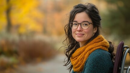 Smiling woman glasses scarf autumnal background wheelchair.