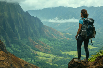 Obraz premium Female hiker admiring mountainous landscape overlooking lush valley