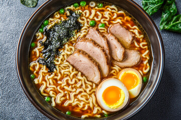 Delicious bowl of ramen noodles with sliced pork, seaweed, and boiled egg