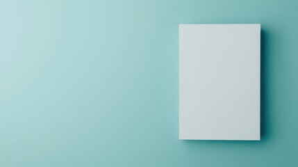 Fototapeta premium Minimalist Background with Blank Vertical Canvas on a Soft Turquoise Wall Perfect for Mockups, Art Displays, and Creative Projects in Contemporary Design