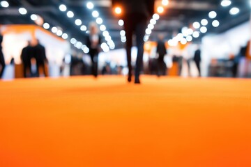 Fototapeta premium People walking on an orange carpet in a modern building.