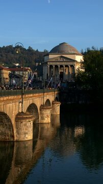 Italy, Turin, 11-10-2024. Gran Madre di Dio with famous bridge Vittorio Emanuele I at sunset. City of Turin. Slow motion. Vertical video