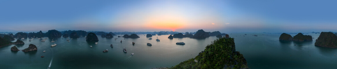 Naklejka premium Aerial view of Ti Top Beach island, Ha Long Bay, Halong Bay is a UNESCO World Heritage Site and popular travel destination, Vietnam. Cruise ships and islands. Sunset