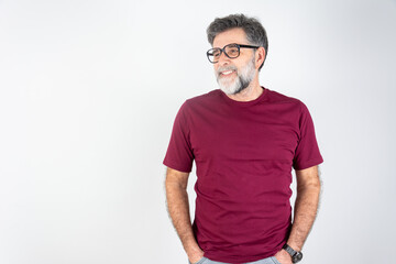 Portrait of happy fashionable handsome man in red t-shirt and glasses standing and smiling.
