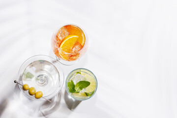 A vibrant display of cocktails, including Aperol Spritz, Mojito, and Martini