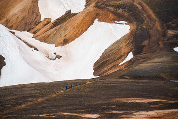 Volcanic mountain with group of hiker hiking on hill in summer at Iceland