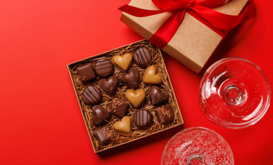 A glasses of champagne elegantly paired with a box of rich chocolates