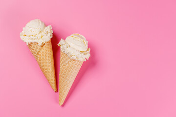 A refreshing ice cream cones set against a vibrant pink background