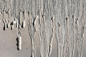 drained frozen mud texture. Gray light brown uneven background
