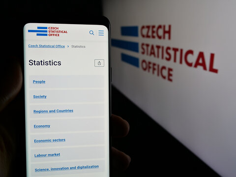 Stuttgart, Germany - 11-22-2024: Person holding smartphone with webpage of Czech Statistical Office (CSO) on screen in front of logo. Focus on center of phone display.