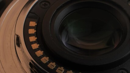 A detailed view of a camera lens that showcases its intricate mechanics and elegant design features