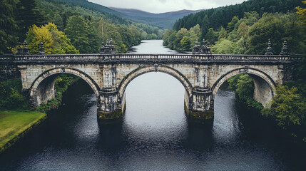 Fototapeta premium A medieval stone bridge crossing a wide river, with elegant arches and detailed carvings along the structure.