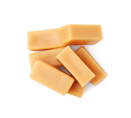 Tasty sweet caramel candies isolated on white, top view