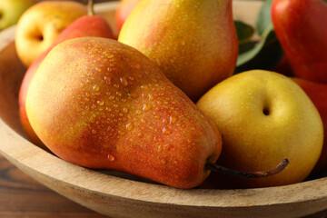 Ripe juicy pears on wooden table, closeup