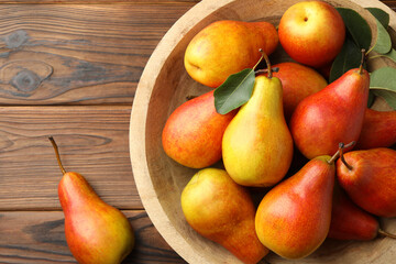 Ripe juicy pears on wooden table, top view