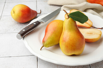 Ripe juicy pears on light tiled table, closeup