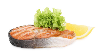 Tasty grilled salmon steak with salt, lemon and lettuce isolated on white