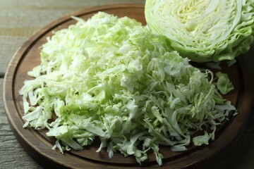 Fresh shredded cabbage on wooden table, closeup