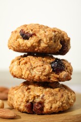 Delicious oatmeal cookies with raisins and nuts on table, closeup