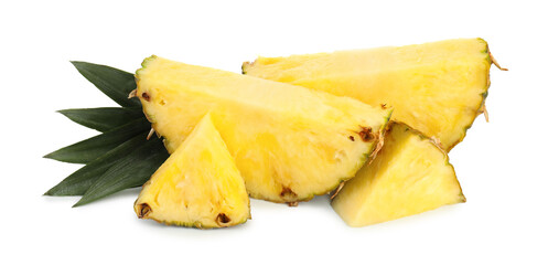 Slices of ripe pineapple and green leaves isolated on white
