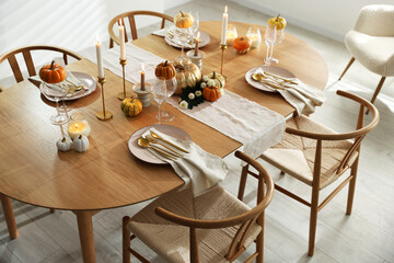Stylish dining room with beautiful table setting and autumn decor
