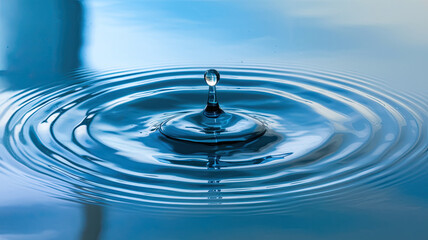 Water Droplet Creating Concentric Ripples on Surface, Central Reflection, Circular Pattern of Ripples, Serene Blue Color Palette, Calming and Peaceful Ambiance