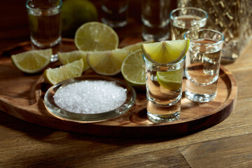 Gold tequila with salt and lime slices.