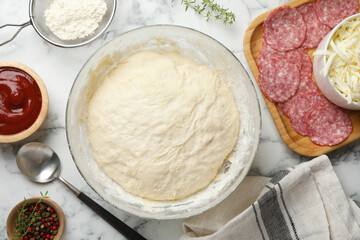 Making calzone pizza. Different ingredients on white marble table, flat lay