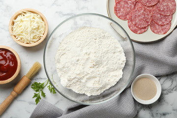 Making calzone pizza. Different ingredients on white marble table, flat lay