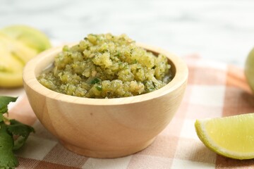 Spicy salsa and ingredients on table, closeup