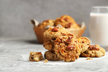 Tasty cookies with nuts on grey table, closeup
