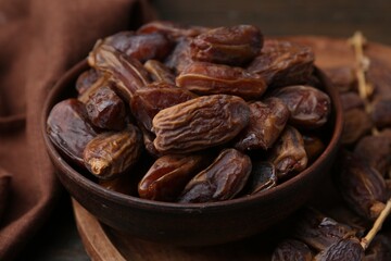 Tasty dried dates on wooden table, closeup