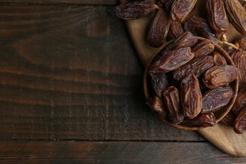 Tasty dried dates on wooden table, top view. Space for text