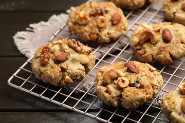 Tasty cookies with nuts on wooden table, closeup
