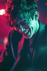 Smiling Young Man in Neon Lights at Night Club