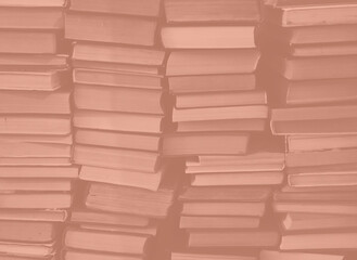 Mocha Mousse color chaotic stack of old books background. Background from old books that are exhibited in a chaotic manner. Colour of the year 2025.