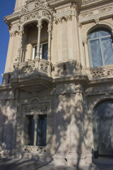 Fototapeta premium facade of an ancient building with a window and a balcony, and an arched opening