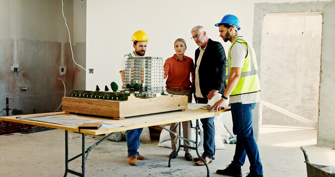 Engineering, meeting and people at construction site with model, planning and building development. Investor, workers and 3D display on table for renovation, infrastructure and investment opportunity