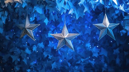 Decorative silver stars hanging against a vibrant blue background creating a whimsical and enchanting atmosphere for celebrations.