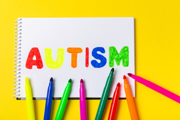 Autism awareness day.2 April world autism awareness day background.Design element.Care Awareness campaign for Autism.AUTISM text with colorful wooden puzzles, letters and cubes.Space for text.Top view