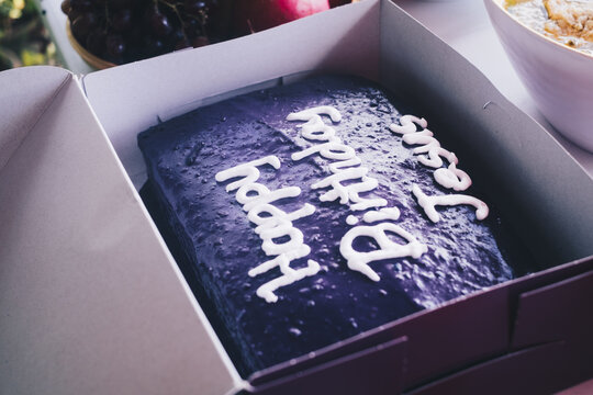 Purple yam cake with "Happy Birthday Jesus" text lettering design during Merry Christmas day party. Selective focus. Isolated. Closeup.
