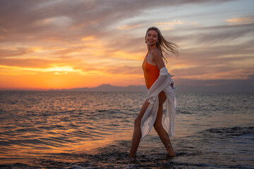 Woman Enjoying Sunset at the Beach
