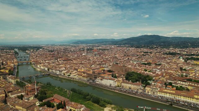Florence, capital of Tuscany region. Home of Renaissance art and architecture. Aerial drone view iconic sight Duomo Cathedral of Santa Maria del Fiore with beautiful city landscape and Arno River