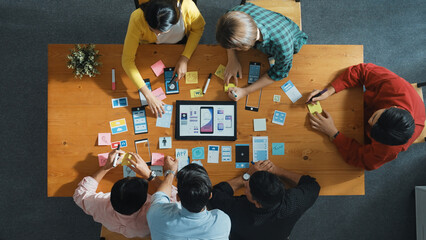 Top view of software developer team looking Ux Ui design for mobile phone interface from tablet...