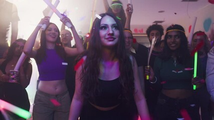 Vibrant Nightlife Energy: Young Adults Enjoying a Glow Stick-Themed Party