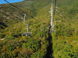 Cable car in the mountains on a background of blue sky.