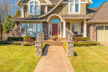 Entrance of grey painted luxury house in summer with stair steps and nice landscape in Vancouver, Canada, North America. Day time on June 2024.
