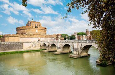 Obraz premium Ponte Sant'Angelo leads to Castel Sant’Angelo, also known as the Mausoleum of the Roman Emperor Hadrian, a fortress located on the right bank of the Tiber River, a short distance from Vatican City.