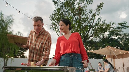 Family all together camp in garden, Old couple grill food for family member. Outdoor camping...